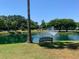 Picturesque pond view with a fountain, bench, palm tree and playground on the grounds at 2011 N Highway 17 # 1100I, Mount Pleasant, SC 29466