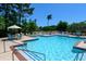 Community swimming pool surrounded by lounge chairs and lush landscaping under a clear blue sky at 2011 N Highway 17 # 1100I, Mount Pleasant, SC 29466