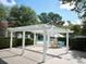 Inviting outdoor pergola with chairs and a table, with a pool in the background at 2011 N Highway 17 # 1100I, Mount Pleasant, SC 29466