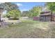 Expansive backyard featuring a brick patio and a vintage outbuilding nestled among mature trees at 208 Owens Dr, Summerville, SC 29485