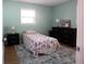 Bright bedroom featuring blue walls, a twin bed, and dark wood furniture at 208 Owens Dr, Summerville, SC 29485