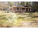 A cozy single-story home surrounded by a lush lawn and flowering shrubs at 208 Owens Dr, Summerville, SC 29485