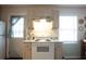 Bright kitchen featuring a white stove, and a convenient access door at 208 Owens Dr, Summerville, SC 29485