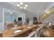 Bright dining room featuring hardwood floors and an elegant chandelier, flowing to the living room at 215 Angora Way, Summerville, SC 29485