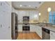 Galley kitchen featuring stainless steel appliances, granite countertops, and white cabinets at 215 Angora Way, Summerville, SC 29485