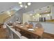 Open-concept living area with dining table, hardwood flooring, kitchen and stairs at 215 Angora Way, Summerville, SC 29485
