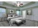 Primary bedroom with tray ceilings, a king bed, and neutral carpet at 215 Angora Way, Summerville, SC 29485