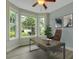 Well-lit home office with a modern desk, comfortable chair, and ample views of the front yard at 215 Angora Way, Summerville, SC 29485