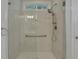 Modern glass walk-in shower featuring multiple shower heads and white tile at 215 Angora Way, Summerville, SC 29485