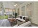 A sunroom with a white couch and chairs, a ceiling fan, and many windows at 215 Angora Way, Summerville, SC 29485