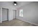 Bedroom with light gray walls and flooring, featuring a double bi-fold closet and window at 2460 Surprise St, North Charleston, SC 29405