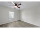Bedroom features wood-look flooring, a ceiling fan, and a window at 2460 Surprise St, North Charleston, SC 29405