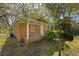 Lovely brick house features a covered porch, well-kept lawn, and established trees, blending charm with a peaceful setting at 2460 Surprise St, North Charleston, SC 29405