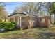 Charming brick home with a covered porch and green lawn, offering a blend of comfort and traditional style at 2460 Surprise St, North Charleston, SC 29405