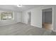 Bright room featuring sleek, light gray wood floors and freshly painted walls, perfect for versatile use at 2460 Surprise St, North Charleston, SC 29405