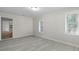 Bright room featuring sleek, light gray wood floors and freshly painted walls, perfect for versatile use at 2460 Surprise St, North Charleston, SC 29405