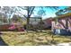Backyard featuring a swing set, brick house, and various plants offering a serene outdoor space at 2467 Birkenhead Dr, Charleston, SC 29414