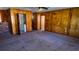 Spacious basement area with wood-paneled walls, carpeted floor, and access to laundry at 2467 Birkenhead Dr, Charleston, SC 29414