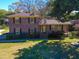 Charming brick two-story home featuring a well-manicured lawn and mature shade trees at 2467 Birkenhead Dr, Charleston, SC 29414
