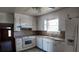 Charming kitchen featuring white cabinetry, standard appliances, and a window providing natural light at 2467 Birkenhead Dr, Charleston, SC 29414
