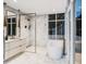 Bathroom featuring a sleek vanity, modern bathtub, and spacious walk-in shower with premium fixtures and finishes at 304 Carolina Blvd, Isle of Palms, SC 29451