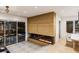 Cozy living area featuring a modern fireplace, seamless indoor/outdoor flow to the pool area at 304 Carolina Blvd, Isle of Palms, SC 29451