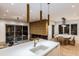 Open-concept living area featuring a modern kitchen island, fireplace, and dining space at 304 Carolina Blvd, Isle of Palms, SC 29451