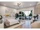 Bright main bedroom with wooden floors, ceiling fan, sitting area and access to a private balcony with ocean view at 304 Carolina Blvd, Isle of Palms, SC 29451