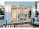 A peek at the main bedroom through sliding glass doors from the outdoor balcony and seating area at 304 Carolina Blvd, Isle of Palms, SC 29451