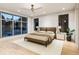Bright main bedroom with large windows, ceiling fan, and a cozy area rug at 304 Carolina Blvd, Isle of Palms, SC 29451