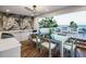 Outdoor dining area with modern table and chairs, kitchen, and scenic ocean views at 304 Carolina Blvd, Isle of Palms, SC 29451