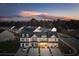 Aerial view of newly built townhomes with private driveways and inviting front porches at sunset at 314 Green Fern Dr, Summerville, SC 29483