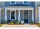 Welcoming townhome entrance with a cozy seating area on the front porch at 316 Green Fern Dr, Summerville, SC 29483