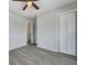 Bedroom with light gray walls, ceiling fan, closet, and modern flooring at 3564 Blanding Dr, Johns Island, SC 29455
