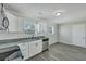 Bright kitchen showcasing white cabinets, stainless steel appliances, and gray laminate flooring at 3564 Blanding Dr, Johns Island, SC 29455