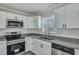 Modern kitchen features granite counters, white cabinets, and stainless steel appliances at 3564 Blanding Dr, Johns Island, SC 29455