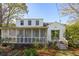 Home featuring a screened-in porch and lush landscaping, creating a private retreat at 4 St Teresa Dr, Charleston, SC 29407