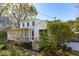 Home featuring a screened-in porch, lush landscaping, and a patio creating an inviting outdoor space at 4 St Teresa Dr, Charleston, SC 29407