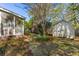 Backyard with a storage shed and a screened in porch with mature landscaping creating a serene environment at 4 St Teresa Dr, Charleston, SC 29407