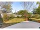 Backyard featuring a concrete patio, lawn, blossoming plants and a wood fence at 4 St Teresa Dr, Charleston, SC 29407
