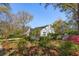 Lush backyard featuring mature trees and shrubs, providing a private and serene outdoor space at 4 St Teresa Dr, Charleston, SC 29407