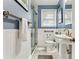 Cozy blue and white bathroom featuring a glass door shower and a pedestal sink at 4 St Teresa Dr, Charleston, SC 29407
