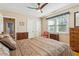 This bedroom features a ceiling fan, neutral walls, and large windows that provide ample natural light at 4 St Teresa Dr, Charleston, SC 29407