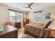 Sunlit bedroom with hardwood floors, ceiling fan, and traditional furnishings at 4 St Teresa Dr, Charleston, SC 29407