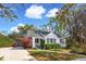 Charming single-story home with a manicured lawn, mature landscaping, and a paved driveway under a blue sky at 4 St Teresa Dr, Charleston, SC 29407