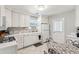 Bright kitchen with white cabinetry, tile backsplash, modern appliances, and a breakfast nook at 4 St Teresa Dr, Charleston, SC 29407