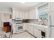 Well-lit kitchen with white cabinets, tile flooring, stainless steel appliances, and a breakfast area at 4 St Teresa Dr, Charleston, SC 29407