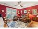 Cozy living room with paneled walls, ceiling fan, and comfortable seating, leading to an outdoor area at 4 St Teresa Dr, Charleston, SC 29407