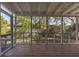 This inviting screened porch offers outdoor living with lush landscaping views and a deck area at 4 St Teresa Dr, Charleston, SC 29407