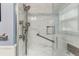 A close-up view of a shower with marble tile and a grab bar in a luxurious bathroom at 4 St Teresa Dr, Charleston, SC 29407